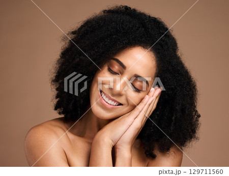 Beauty, skincare and smile with face of black woman for skincare, glow and cosmetics. Facial, spa and relax with girl model for product, makeup and wellness dermatology in brown background studio 129711560