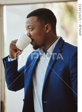 Thinking, black businessman or drinking coffee in airport lounge, hotel lobby or modern office building. Corporate worker, employee or manager with tea cup, innovation vision or company growth idea 129711631