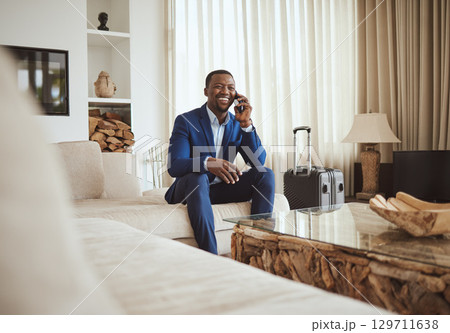 Happy businessman in hotel, on smartphone call and business communication for work in Atlanta. Young black entrepreneur, listening to audio on cellphone and sitting on luxury sofa in living room Happy businessman in hotel, on smartphone call and business communication for work in Atlanta. Young black entrepreneur, listening to audio on cellphone and sitting on luxury sofa in living room 129711638
