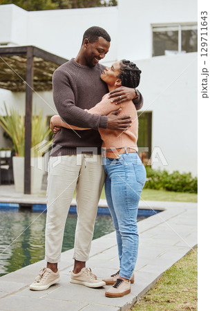 Black couple, house and swimming pool property while outdoor for a hug, love and care while happy about real estate. Man and woman at their new home with pride and smile for mortgage loan approval 129711643