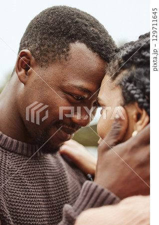 Black couple, forehead and smile for love, embrace or happy relationship bonding together in the outdoors. Black man touching heads and holding woman in romance, support or hug for partnership 129711645