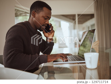 Remote work, phone call and black man typing on laptop in home office for online consulting, trading and email. Freelancer talking on mobile communication with service provider of computer internet Remote work, phone call and black man typing on laptop in home office for online consulting, trading and email. Freelancer talking on mobile communication with service provider of computer internet 129711714