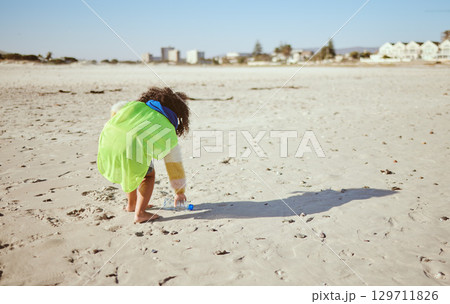 Plastic bottle, beach and child recycling for ocean, earth day or climate change education, learning and volunteer support in nonprofit. Girl recycle, environment and bottle on ground for pollution 129711826