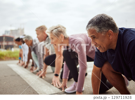 Start, fitness or senior people in a marathon race with running goals in workout or runners exercise. Motivation, focus or healthy group of sports athletes ready for contest on street road in city 129711928