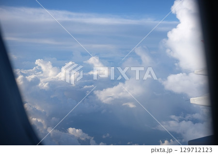 Airplane Wing View with Scenic Clouds and Blue Sky 129712123