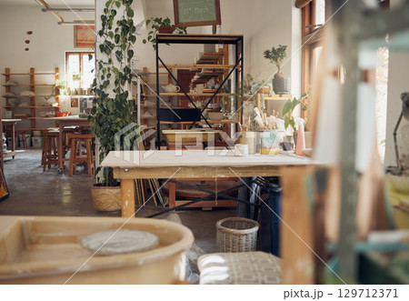 Interior, pottery and workshop of small business in ceramic arts, crafts or creative studio of startup business. Empty work station of a artistic room for clay crafting, paint or molding classroom Interior, pottery and workshop of small business in ceramic arts, crafts or creative studio of startup business. Empty work station of a artistic room for clay crafting, paint or molding classroom 129712371