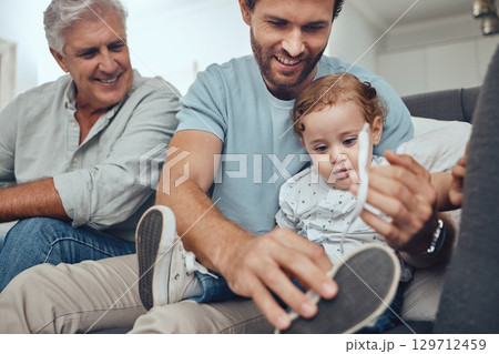 Family, love and dad with child on sofa to tie shoes laces enjoying weekend, quality time and bonding together. Family home, support and grandfather, father and boy relaxing on couch in living room Family, love and dad with child on sofa to tie shoes laces enjoying weekend, quality time and bonding together. Family home, support and grandfather, father and boy relaxing on couch in living room 129712459