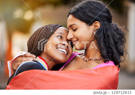 Love, hug and happy lesbian couple at a freedom, equality or LGBTQ festival, event or parade. Happiness, smile and gen z interracial gay women embracing, hugging and bonding together in the city. Love, hug and happy lesbian couple at a freedom, equality or LGBTQ festival, event or parade. Happiness, smile and gen z interracial gay women embracing, hugging and bonding together in the city. 129712615