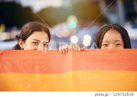 Love, pride flag and portrait of a lesbian couple at a LGBTQ, freedom or community parade in the city. Happy, celebration and interracial gay women with commitment at a LGBT, rainbow sexuality event. Love, pride flag and portrait of a lesbian couple at a LGBTQ, freedom or community parade in the city. Happy, celebration and interracial gay women with commitment at a LGBT, rainbow sexuality event. 129712616