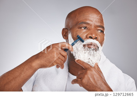 Face, shaving cream and black man with razor on beard, skincare spa treatment on grey background. Health, mock up and facial hair, mature man morning shave routine with space for product placement. Face, shaving cream and black man with razor on beard, skincare spa treatment on grey background. Health, mock up and facial hair, mature man morning shave routine with space for product placement. 129712665
