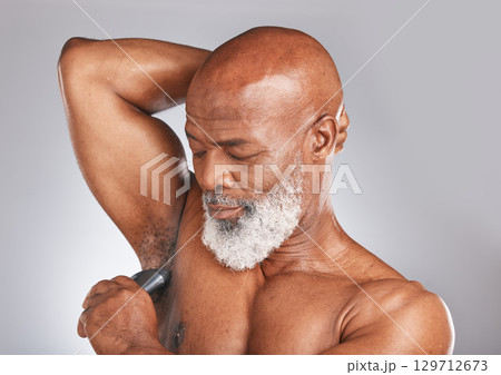Grooming, deodorant and armpit of a senior black man for shower care, hygiene and body health on a grey studio background. Clean, underarms and elderly African model with a product for fresh smell Grooming, deodorant and armpit of a senior black man for shower care, hygiene and body health on a grey studio background. Clean, underarms and elderly African model with a product for fresh smell 129712673