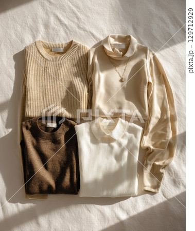 knit sweaters, elegant tops in harmonious palette of neutral colors. From cozy ribbed textures to soft, flowing fabrics, these garments are for building stylish, comfortable cold-weather wardrobe 129712929