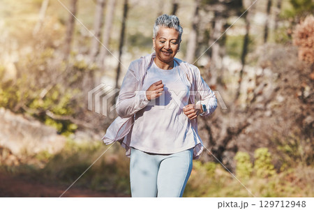 Fitness, runner or old woman running in nature training, exercise or cardio workout in New Zealand park. Happy, elderly or healthy senior person smiles with pride, body goals or motivation in summer 129712948