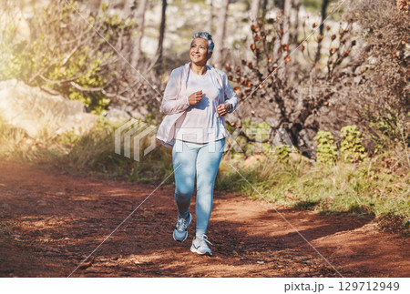 Fitness, happy or old woman running in nature cardio training, exercise or workout in New Zealand. Runner, freedom or healthy senior person smiles with pride, body goals or motivation in summer Fitness, happy or old woman running in nature cardio training, exercise or workout in New Zealand. Runner, freedom or healthy senior person smiles with pride, body goals or motivation in summer 129712949
