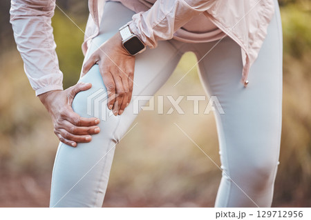 Fitness, knee pain and woman in nature after running, exercise and marathon training for healthy lifestyle. Wellness, sports and hands of female athlete with muscle strain, leg injury and accident 129712956