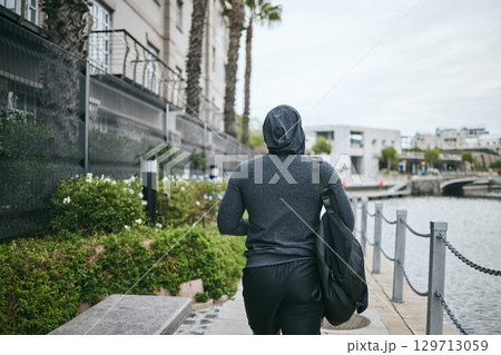 Fitness, hoodie or man walking to gym for body training, exercise or workout with a duffle bag in Miami, Florida. City, mindset or healthy sports athlete with wellness goals, motivation or mission Fitness, hoodie or man walking to gym for body training, exercise or workout with a duffle bag in Miami, Florida. City, mindset or healthy sports athlete with wellness goals, motivation or mission 129713059