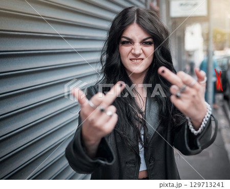 Face portrait, middle finger and woman in city with rude gesture or insult. Punk fashion, goth and female in street with anger, aggressive and bad hands sign, symbol or emoji for conflict expression 129713241