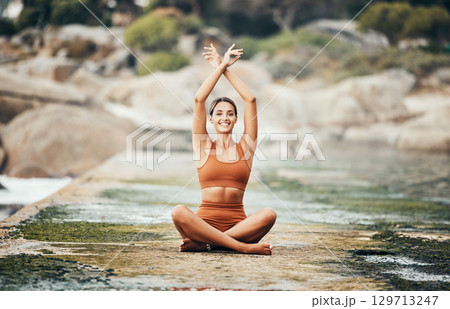 Fitness, yoga and zen, woman at beach stretching for meditation and training in nature for healthy lifestyle. Health, wellness and workout for girl at ocean, pilates exercise for balance at sea water 129713247