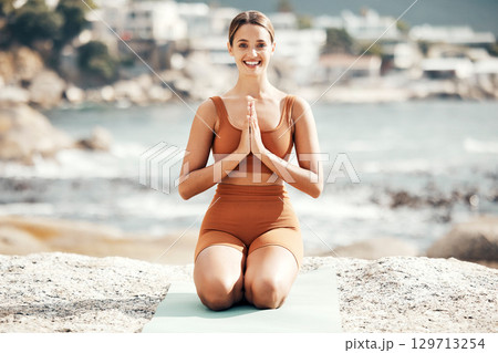 Fitness, yoga and zen, portrait of woman at beach stretching for meditation and training in nature for healthy lifestyle. Health, wellness and workout at ocean, pilates exercise and balance at sea. 129713254