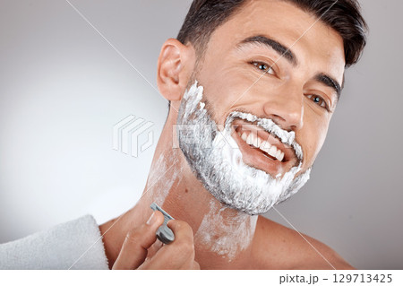Grooming, foam and shaving with face of man with razor for beauty, hygiene and skincare with morning routine. Self care, facial and shave beard with model and cream product for wellness and cleaning Grooming, foam and shaving with face of man with razor for beauty, hygiene and skincare with morning routine. Self care, facial and shave beard with model and cream product for wellness and cleaning 129713425