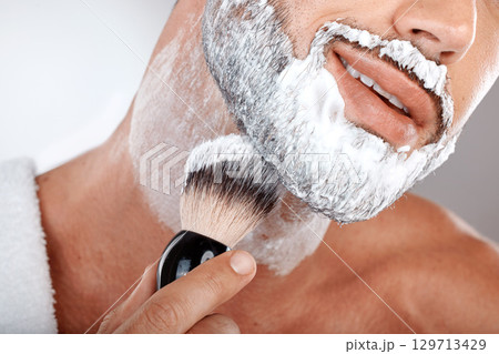 Closeup, man and brush for shaving cream in studio for self care, grooming and facial hygiene with smile. Model, beard and foam for shaving, self love and cleaning for beauty, zoom and skincare Closeup, man and brush for shaving cream in studio for self care, grooming and facial hygiene with smile. Model, beard and foam for shaving, self love and cleaning for beauty, zoom and skincare 129713429