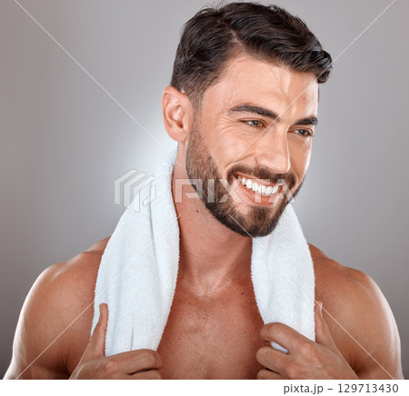 Man with towel, beauty and face with skincare, hygiene and self care against studio background. Grooming, skin and glow with cosmetic, facial wellness and happy male with beard, clean teeth and smile Man with towel, beauty and face with skincare, hygiene and self care against studio background. Grooming, skin and glow with cosmetic, facial wellness and happy male with beard, clean teeth and smile 129713430