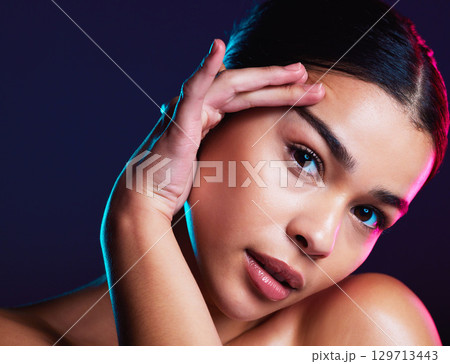 Woman, makeup and skincare in dark studio for beauty, cosmetics or self love with light on face. Model, natural cosmetic glow or skin wellness portrait for self care, shine or health by background Woman, makeup and skincare in dark studio for beauty, cosmetics or self love with light on face. Model, natural cosmetic glow or skin wellness portrait for self care, shine or health by background 129713443