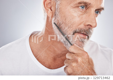Beard comb, senior man and face on studio background for barber cleaning, body wellness and skincare. Male model brushing facial hair for healthy maintenance, aesthetic beauty and hair care cosmetics Beard comb, senior man and face on studio background for barber cleaning, body wellness and skincare. Male model brushing facial hair for healthy maintenance, aesthetic beauty and hair care cosmetics 129713462