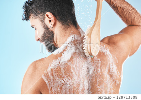 Back, man and shower with foam, skincare and cleaning for body care, wellness and against blue studio background. Male, guy and washing with water, beauty and cosmetics for grooming, bare and fresh Back, man and shower with foam, skincare and cleaning for body care, wellness and against blue studio background. Male, guy and washing with water, beauty and cosmetics for grooming, bare and fresh 129713509