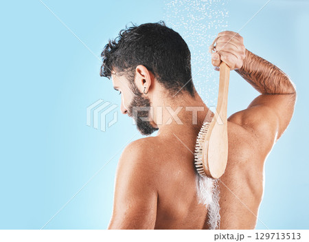 Shower, man and soap for body cleaning with brush in blue background studio, grooming hygiene and skincare wellness. Model, water and luxury spa body care, dermatology and self care morning routine Shower, man and soap for body cleaning with brush in blue background studio, grooming hygiene and skincare wellness. Model, water and luxury spa body care, dermatology and self care morning routine 129713513
