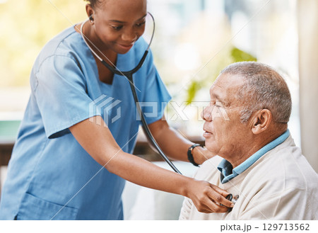 Nurse, senior patient and stethoscope for healthcare service, caregiver career or heart check in hospital, clinic or retirement home. Nursing, consulting and cardiology of elderly man and black woman 129713562