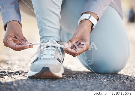 Woman, hands and shoelace for street runner, outdoor workout and fitness in summer sunshine in morning. Running adventure, shoes and tie lace for safety, speed and balance in road exercise for health Woman, hands and shoelace for street runner, outdoor workout and fitness in summer sunshine in morning. Running adventure, shoes and tie lace for safety, speed and balance in road exercise for health 129713578