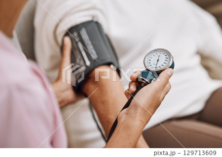 Blood pressure, hypertension and nurse with patient to check diabetes, healthcare consulting and service in clinic. Closeup hands of woman doctor measure arm pulse, medical test and heart wellness Blood pressure, hypertension and nurse with patient to check diabetes, healthcare consulting and service in clinic. Closeup hands of woman doctor measure arm pulse, medical test and heart wellness 129713609