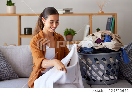 Cleaning, home and cleaner folding laundry while cleaning in modern living room for hygiene. Spring cleaning, washing and female maid or housewife from Puerto Rico with clothes for housekeeping duty. Cleaning, home and cleaner folding laundry while cleaning in modern living room for hygiene. Spring cleaning, washing and female maid or housewife from Puerto Rico with clothes for housekeeping duty. 129713650