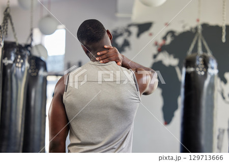 Fitness, neck pain and massage with black man in gym for training, workout and exercise. Injury, strain and physical therapy with athlete training in sports center for muscle, endurance and power 129713666