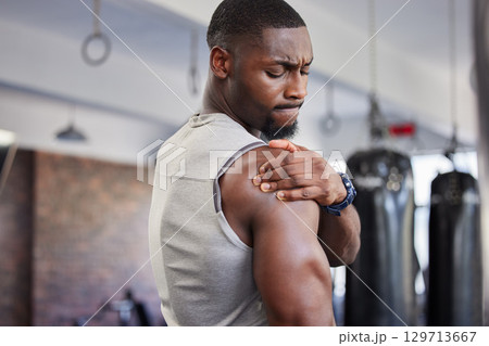 Exercise, black man and shoulder pain for training, fitness and workout for wellness in gym. Nigerian male, athlete and body care with pain, tired and injury for ache, strong and orthopedic problem 129713667