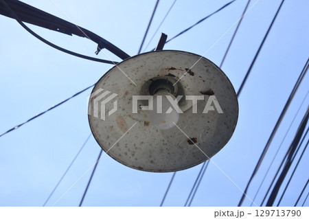 lighting on electric poles with a blue sky nuance 129713790