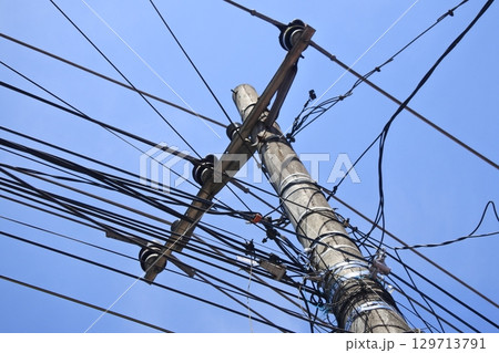 electric pole with blue sky background electric pole with blue sky background 129713791