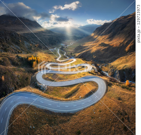 Aerial view of winding mountain road in the Swiss Alps Aerial view of winding mountain road in the Swiss Alps 129713973