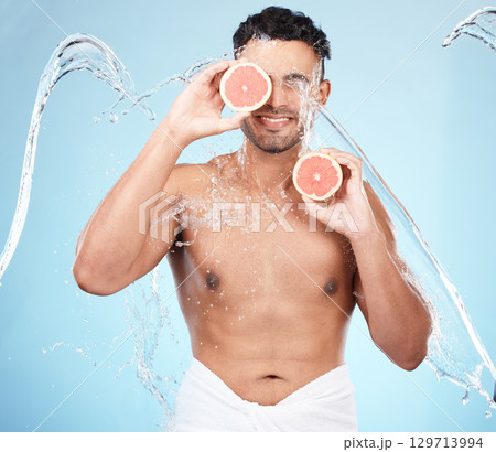 Skincare, beauty and water splash, man with fruit for vitamin c facial detox for healthcare, natural healthy skin and smile. Water, wellness and sustainability, organic luxurycleaning and grooming. 129713994