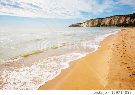 Breathtaking sea with white fluffy clouds. Outdoor vacation. 129714055