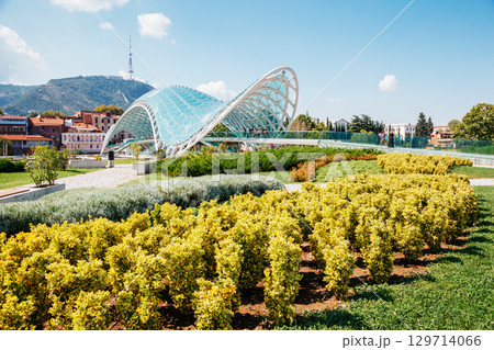 Captivating scene of the bridge of Peace in Tbilisi town. 129714066