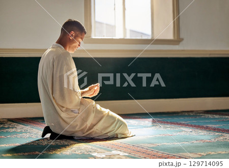 Mosque, worship and muslim man in prayer on his knees for gratitude, support or ramadan for spiritual wellness. Religion, tradition and islamic guy praying or reciting quran to allah at islam temple. Mosque, worship and muslim man in prayer on his knees for gratitude, support or ramadan for spiritual wellness. Religion, tradition and islamic guy praying or reciting quran to allah at islam temple. 129714095