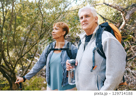 Relax, senior or couple of friends hiking, walking or trekking for freedom, exercise or fitness in nature forest. Interracial, travel or happy woman enjoys bonding time with healthy elderly partner Relax, senior or couple of friends hiking, walking or trekking for freedom, exercise or fitness in nature forest. Interracial, travel or happy woman enjoys bonding time with healthy elderly partner 129714188