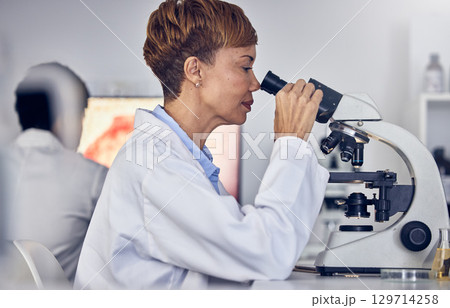 Science, laboratory and black woman with microscope, research for vaccine development. Healthcare, medical innovation and senior scientist woman in hospital lab looking at pharmaceutical test results Science, laboratory and black woman with microscope, research for vaccine development. Healthcare, medical innovation and senior scientist woman in hospital lab looking at pharmaceutical test results 129714258