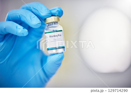Innovation, healthcare or hand with vaccine, medicine or product in bottle with a blurry or blurred background. Monkey pox, doctor or scientist working on medical cure or lab drugs in safety gloves Innovation, healthcare or hand with vaccine, medicine or product in bottle with a blurry or blurred background. Monkey pox, doctor or scientist working on medical cure or lab drugs in safety gloves 129714290