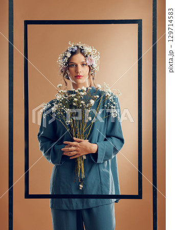 Flowers, woman and portrait with frame and floral aesthetic, marketing and nature against studio background. Style, flower and growth, natural and earth with beauty, cosmetics with spring fashion. Flowers, woman and portrait with frame and floral aesthetic, marketing and nature against studio background. Style, flower and growth, natural and earth with beauty, cosmetics with spring fashion. 129714583