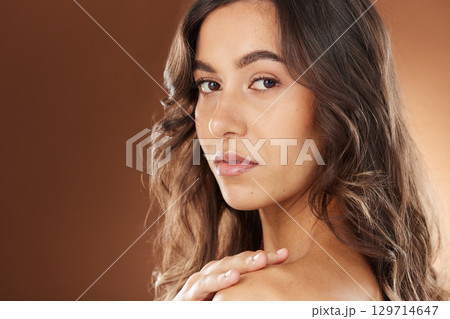 Woman, face skincare or curly hairstyle on studio background in Brazilian keratin treatment, self love or healthcare wellness. Portrait zoom, brunette color or beauty model and natural texture waves 129714647