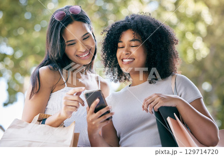 Black woman, shopping and friends with smartphone outdoors for social media retail sales, discount and online fashion deal promo. Planning ecommerce, website shop and browsing internet store together Black woman, shopping and friends with smartphone outdoors for social media retail sales, discount and online fashion deal promo. Planning ecommerce, website shop and browsing internet store together 129714720