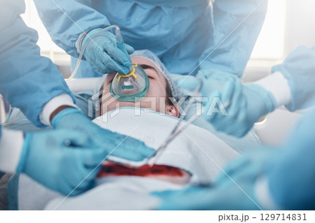 Doctors, surgery and oxygen with a medicine team in scrubs operating on a man patient in a hospital. Doctor, nurse and teamwork with a medical group in a clinic to perform an operation 129714831